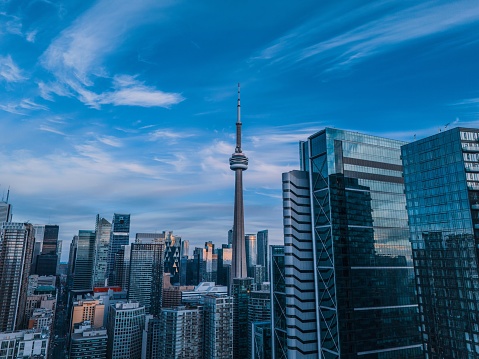 Toronto skyline with CN Tower under blue sky. Toronto, Ontario skyline with CN Tower